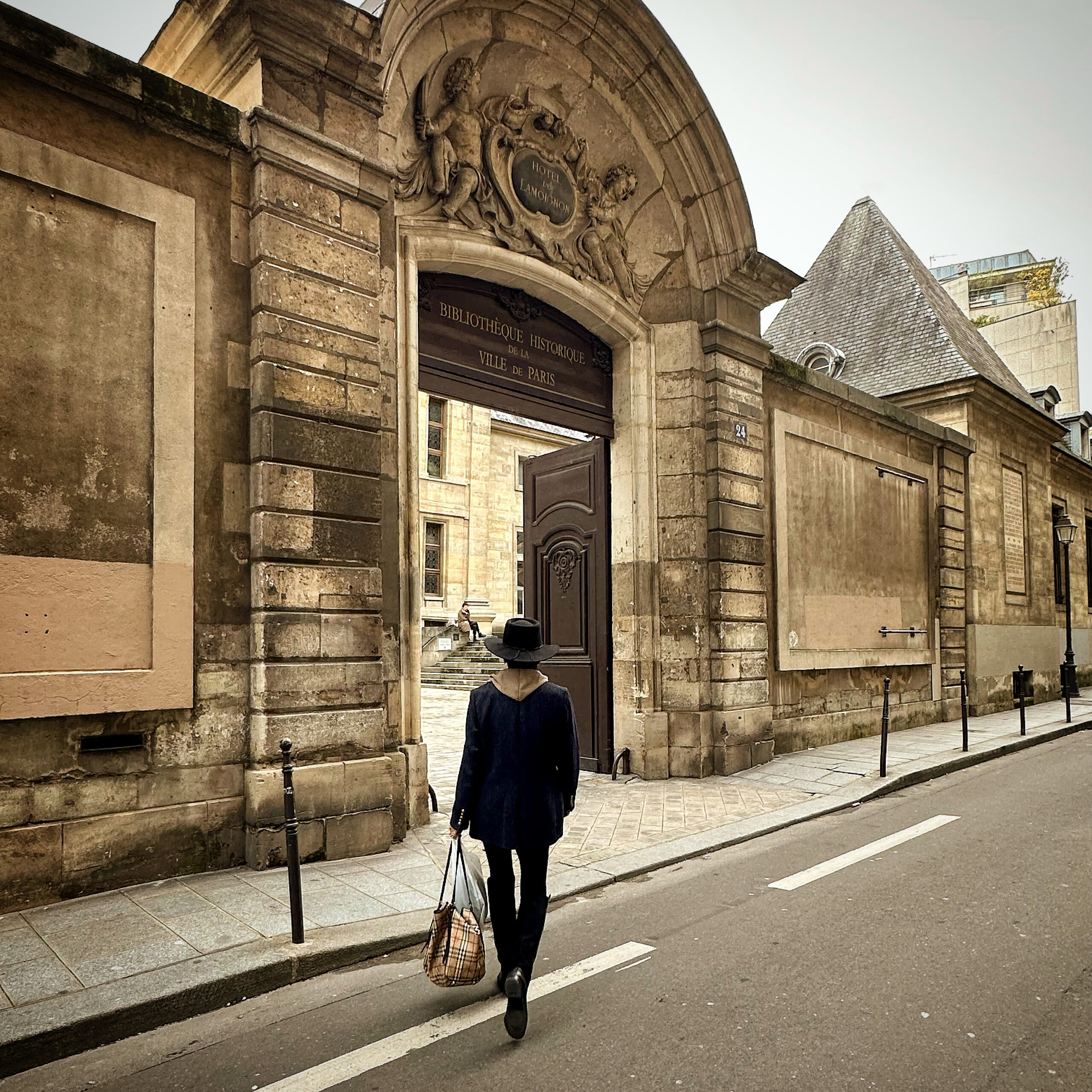 Debbi walking in Paris by beautiful old buildings