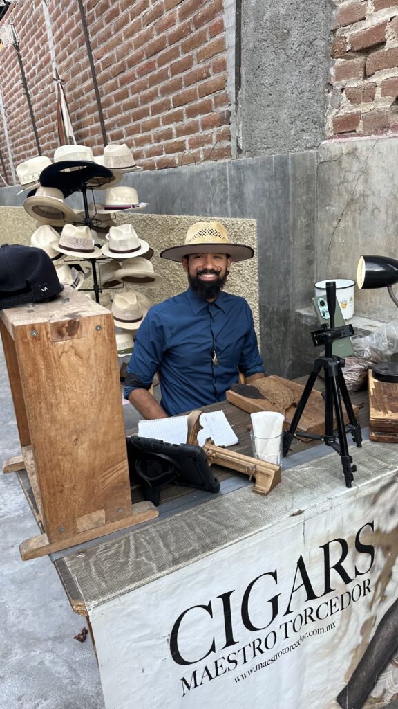 san jose del cabo, a man rolling cigars